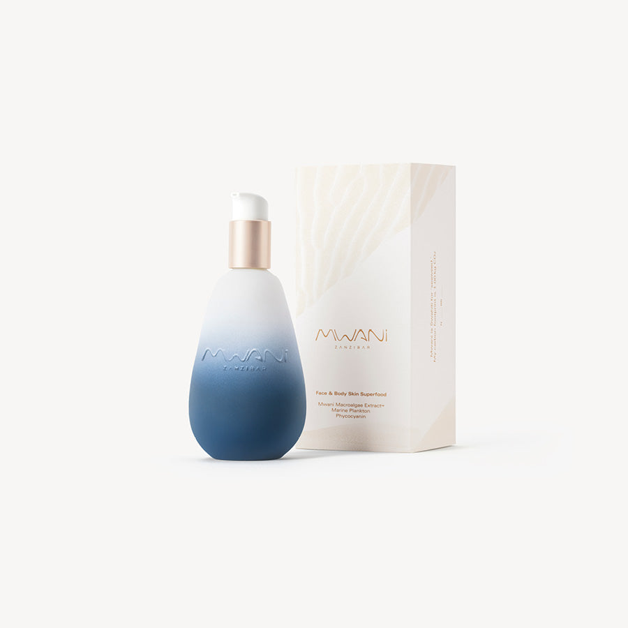 Blue bottle of Mwani Zanzibar’s Face & Body Skin Superfood, next to exterior packaging.