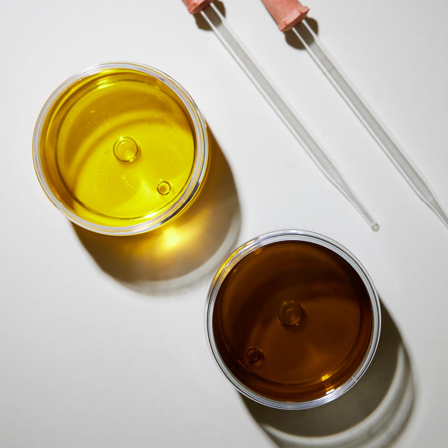 Aerial view of two oils in glass vessels.